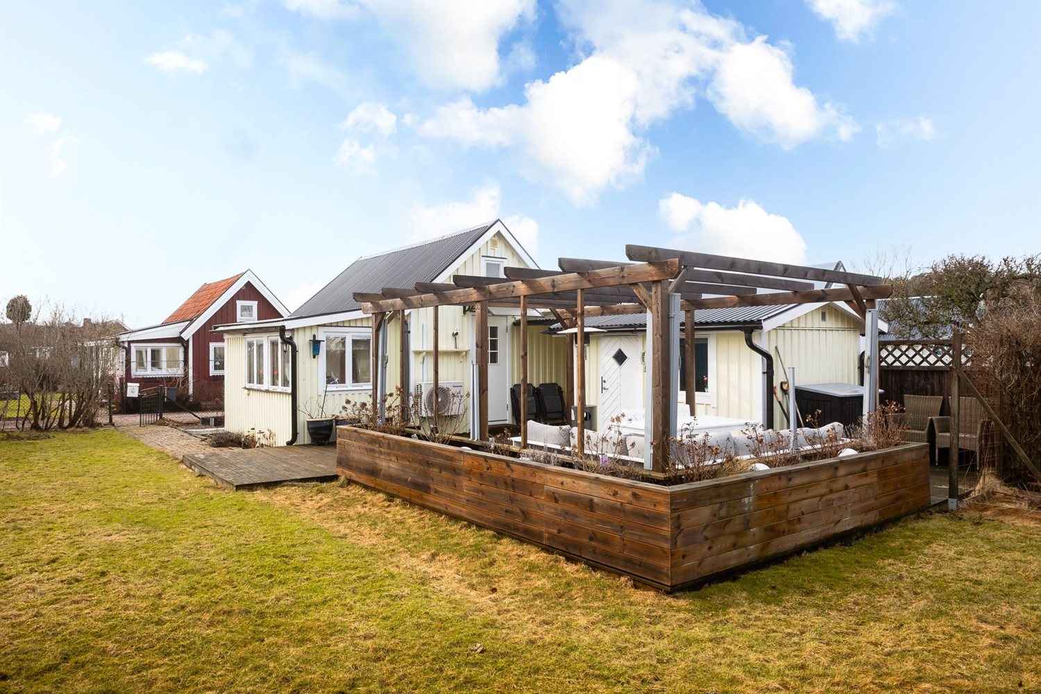 Vy mot stugan från insidan av tomten