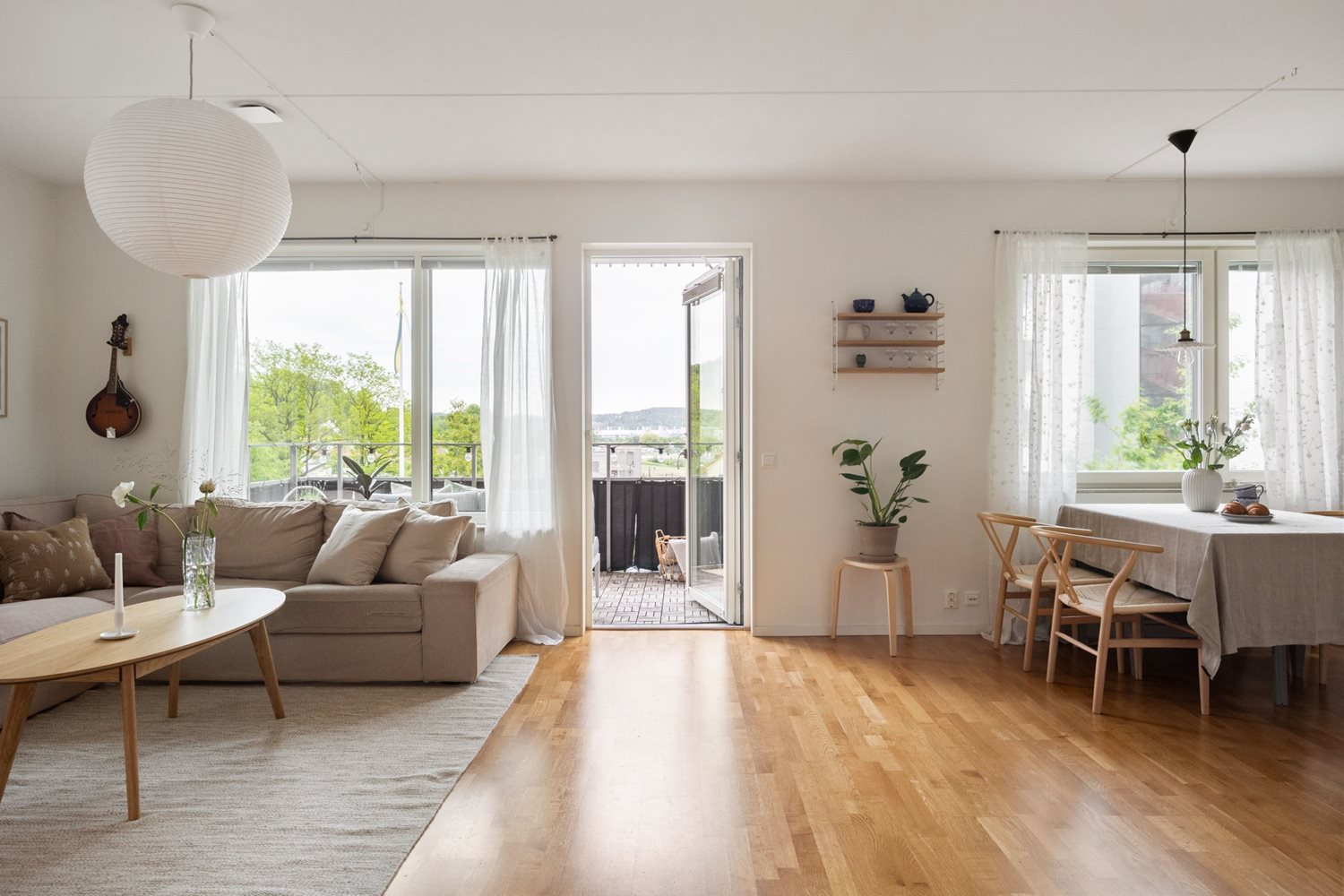 Vy mot vardagsrum och matplats och balkong